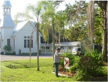 Staff staking a rezoning sign in yard