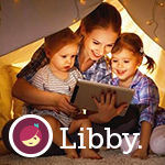 Mother reading to her young children under a play tent.
